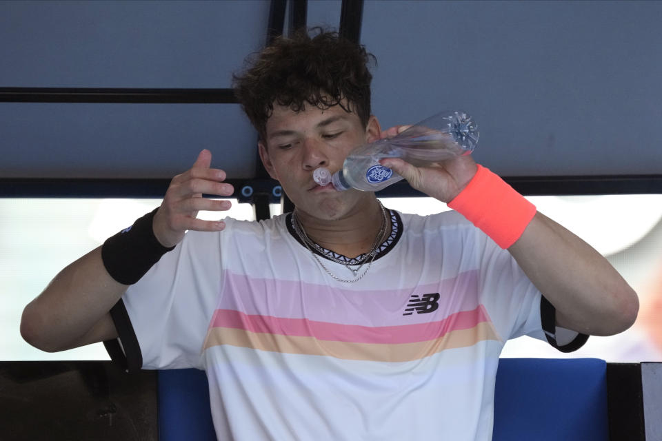 Ben Shelton of the U.S. takes a drink during a break in his quarterfinal against compatriot Tommy Paul at the Australian Open tennis championship in Melbourne, Australia, Wednesday, Jan. 25, 2023. (AP Photo/Aaron Favila)