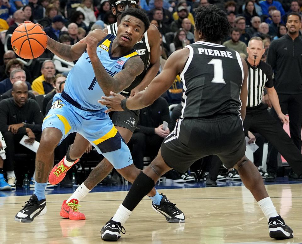 Marquette's Kam Jones makes a move against Providence guard Jayden Pierre in the first half on Wednesday. He led the Golden Eagles with 17 points.