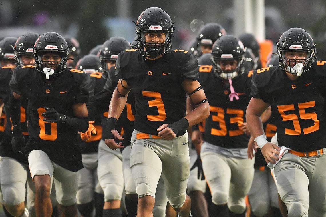 Fuquay-Varina’s Malcolm Ziglar (3) leads his team onto the field before taking on Southeast Raleigh. The Fuquay-Varina Bengals and the Southeast Raleigh Bulldogs played a conference football game in Fuquay-Varina, N.C. on September 22, 2023.