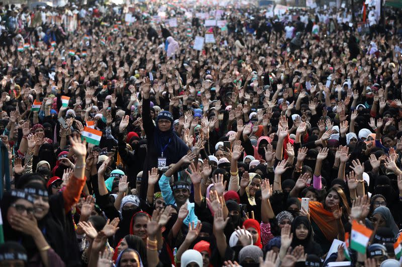 Demonstrators gesture during a protest against a new citizenship law on the outskirts of Mumbai