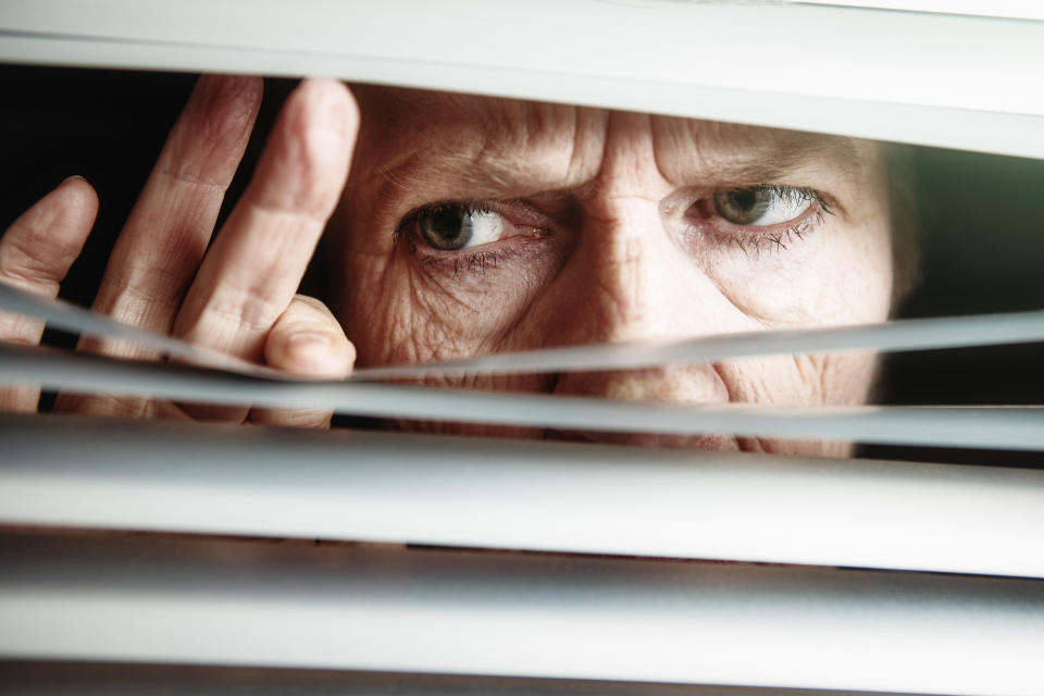 A neighbor looking out the window.