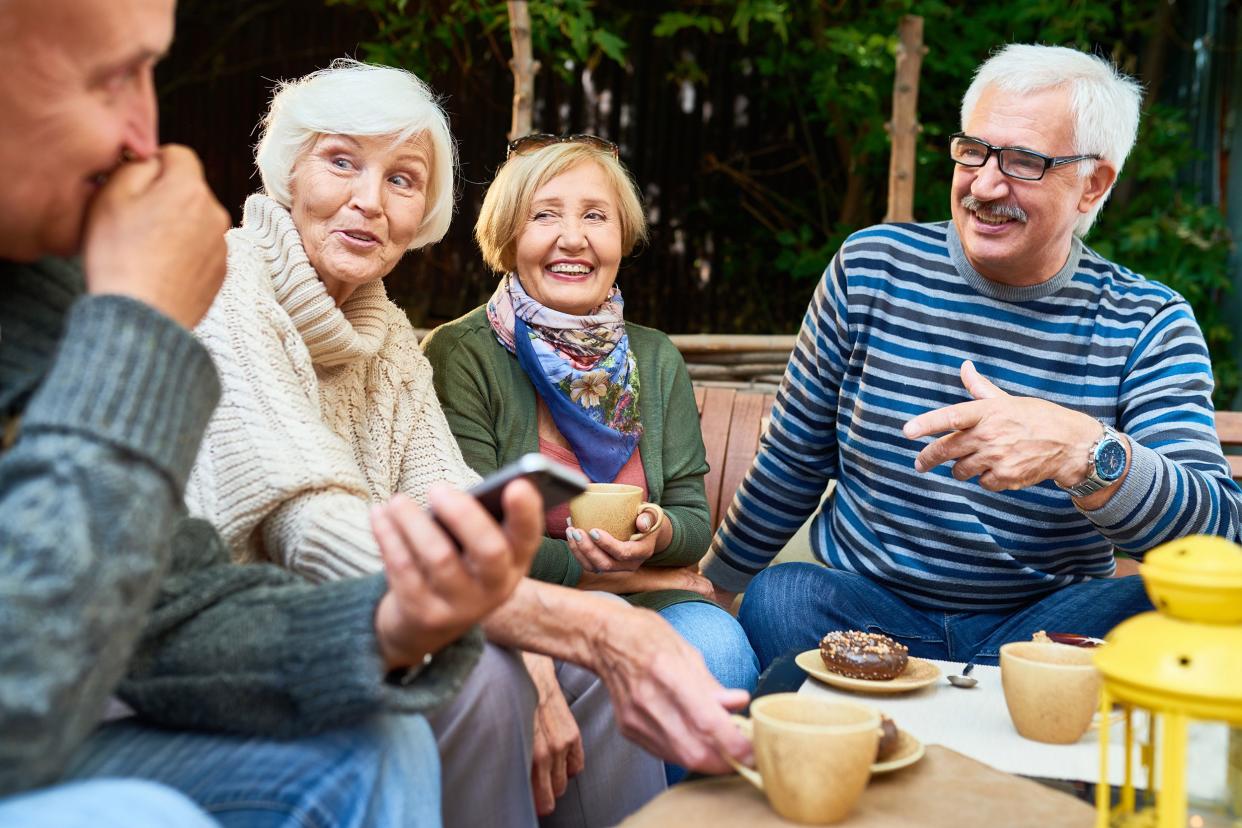 senior friends siting outside on patio