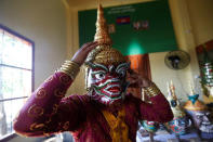 A dancer gets ready before a performance of masked theatre known as Lakhon Khol which was recently listed by UNESCO, the United Nations' cultural agency, as an intangible cultural heritage, along with neighbouring Thailand's version of the dance, known as Khon at the Wat Svay Andet buddhist temple in Kandal province, Cambodia, December 16, 2018. REUTERS/Samrang Pring