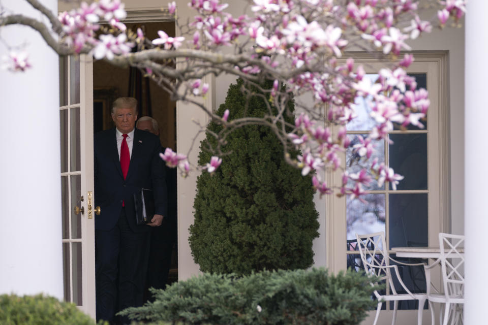 President Donald Trump walks out of the Oval Office for a news conference to declare a national emergency in response to the coronavirus, at the White House, Friday, March 13, 2020, in Washington. (AP Photo/Evan Vucci)