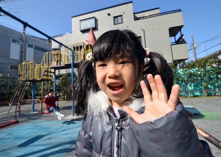 A girl smiles at a playground in a park in Tokyo on March 2, 2013. As Japan's population declines, intolerance of children and the noise they make is increasing in a society getting less accustomed to hearing them, childcare experts say