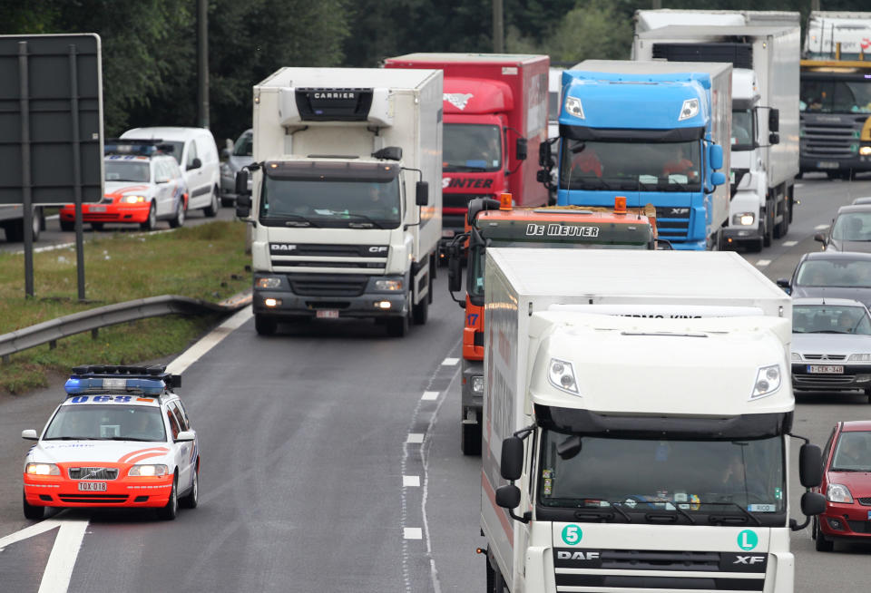 Trucks drive in a slow convoy on the Brussels ring road, as they participate in a demonstration, Monday Sept. 24, 2012. Truckers seek to disrupt morning traffic heading into the capital to protest competition from eastern Europe, which undercuts prices and lowers labor standards. (AP Photo/Yves Logghe)