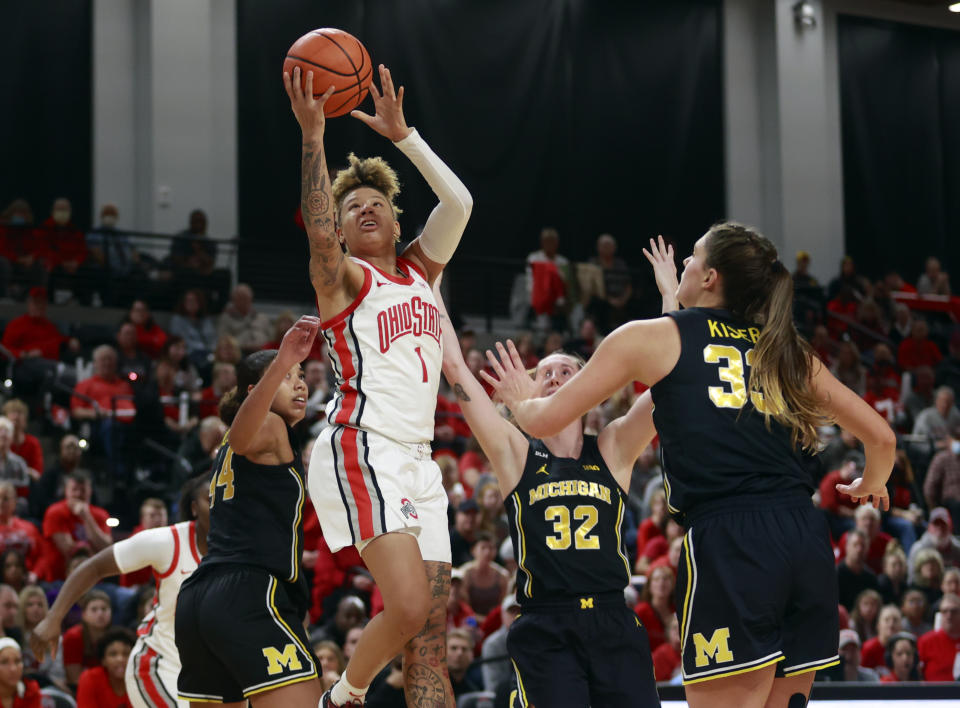 Ohio State guard Rikki Harris (1) shoots between Michigan forward Cameron Williams (44), guard Leigha Brown (32) and forward Emily Kiser (33) during the second half of an NCAA college basketball game in Columbus, Ohio, Saturday, Dec. 31, 2022. Ohio State won 66-57. (AP Photo/Paul Vernon)