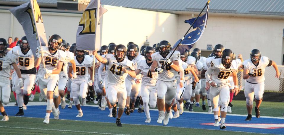 Mooresville runs on the field before Friday's Mid-State Conference game at Martinsville.