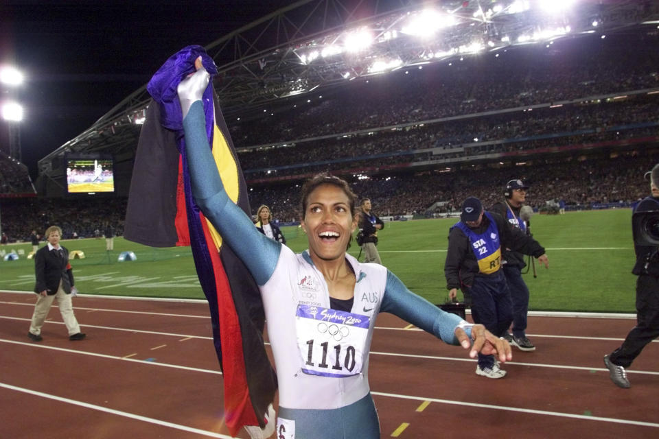 FILE - In this Sept. 25, 2000, file photo, Australia's Cathy Freeman celebrates winning the women's 400 meter race at the Summer Olympics at Olympic Stadium in Sydney. Tony Gustavsson, head coach of Australia's national women's soccer team, called a meeting. Instead of leading the team through a tactical discussion, he told the players he had different plans for the evening."They played about a three-minute highlight reel on YouTube of the moment of Cathy Freeman's race," Matildas defender Aivi Luik said. "And by the end of it, there was a lot of emotion going around in the room. (AP Photo/Thomas Kienzle, File)
