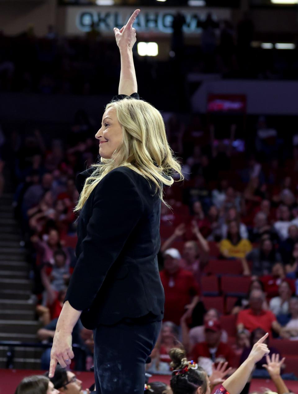 OU coach K.J. Kindler celebrates a perfect 10 by Ragan Smith on the beam during the Women's Big 12 Gymnastics Championship on Saturday at Lloyd Noble Center in Norman.