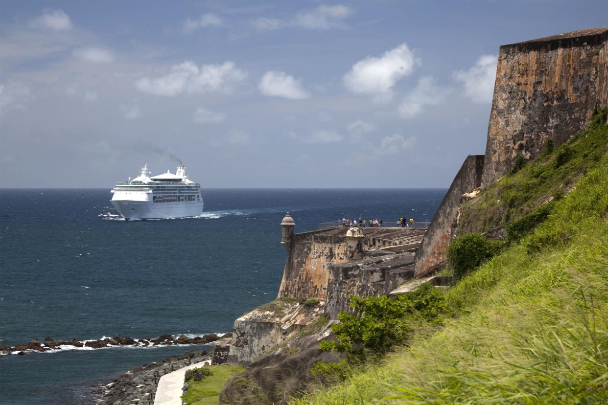 A Cruise Ship enters San Juan Harbor, passing the fortress of El Morro.