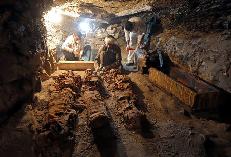 Egyptian antiquities workers preserve mummies in the recently discovered tomb of Amenemhat, a goldsmith from the New Kingdom, at the Draa Abu-el Naga necropolis near the Nile city of Luxor, south of Cairo, Egypt, September 9, 2017. REUTERS/Mohamed Abd El Ghany