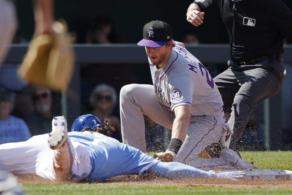 Kansas City Royals' Bobby Witt Jr., left, is tagged out by Colorado Rockies third baseman Ryan McMahon, right, after getting caught off the bag by catcher Elias Diaz during the third inning of a baseball game in Kansas City, Mo., Saturday, June 3, 2023. (AP Photo/Colin E. Braley)