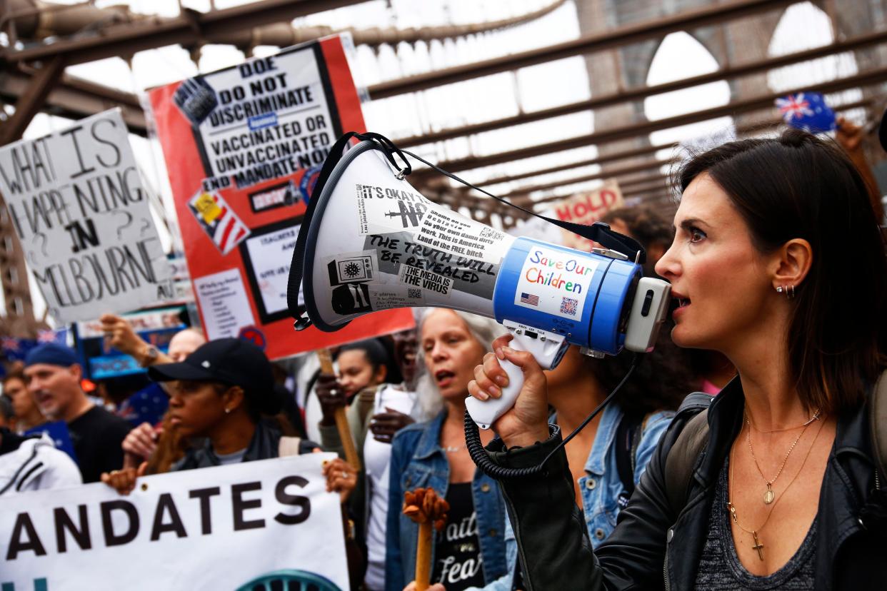 People march as they protest against NYC's coronavirus vaccine mandate in Manhattan, New York.