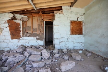 A house is left destroyed by an earthquake, triggered by a previous day quake, near the epicenter in Trona, California