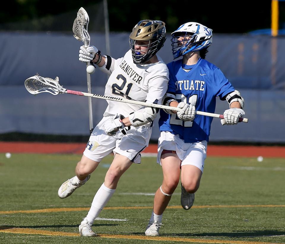 Scituate’s Alex Burrill knocks the ball out of the cradle of Hanover’s Dylan Rice during second quarter action of their game at Hanover High on Thursday, May 20, 2021.