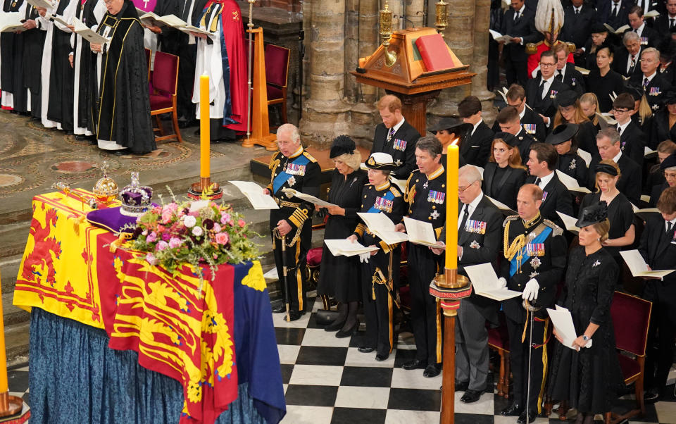 Britain’s Prince Harry, Duke of Sussex, and Meghan, Duchess of Sussex, stand behind King Charles III and Camilla, Queen Consort, before the coffin of Queen Elizabeth II during the State Funeral of Queen Elizabeth II, held at Westminster Abbey, in London England, on Sept. 19, 2022.<span class="copyright">Dominic Lipinski—Pool/Getty Images</span>