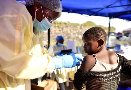 A Congolese health worker administers ebola vaccine to a child at the Himbi Health Centre in Goma