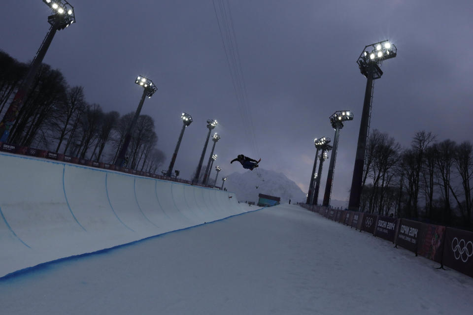 A freestyle skier gets air during men's freestyle skiing half pipe training in the fog at the Rosa Khutor Extreme Park, at the 2014 Winter Olympics, Sunday, Feb. 16, 2014, in Krasnaya Polyana, Russia. (AP Photo/Andy Wong)