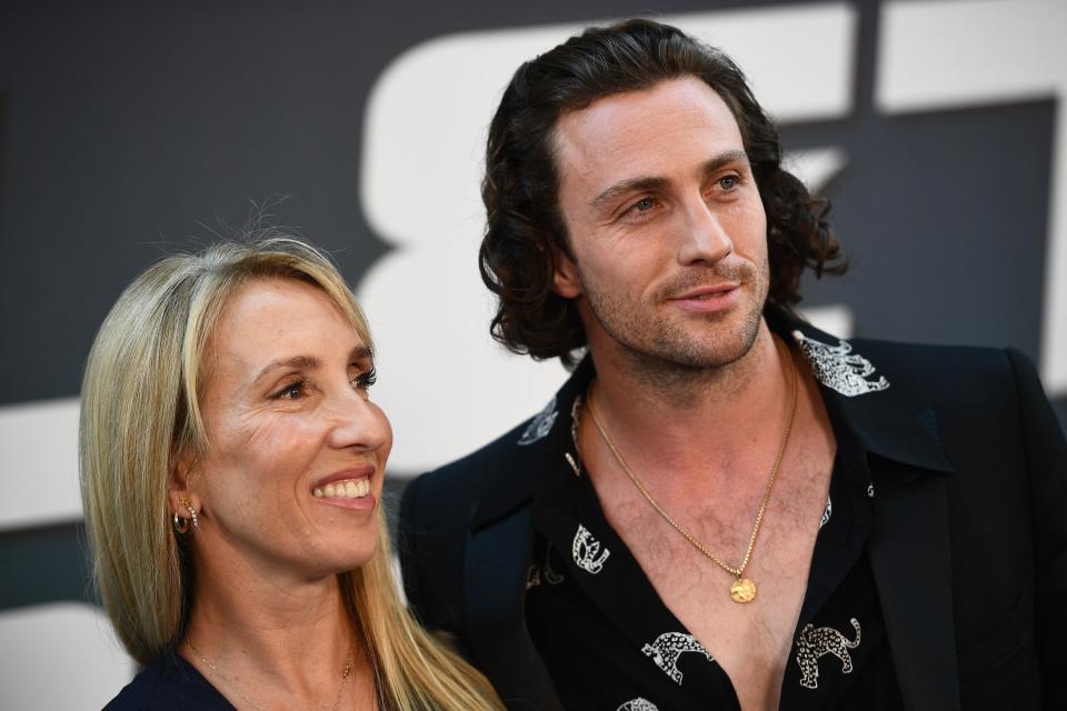 British actor Aaron Taylor-Johnson (R), poses for a picture with his wife British filmmaker Sam Taylor-Johnson during a preview of the film (Bullet Train) in Paris on July 18, 2022. - Come to present the comedy 