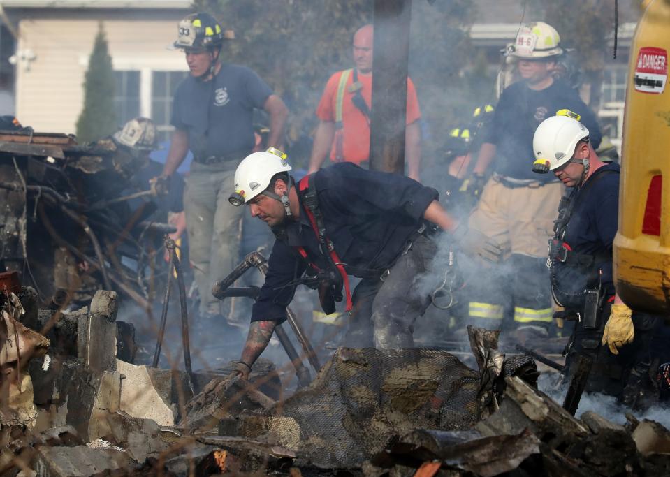 Firefighters work at the scene of a major fire at the Evergreen Court Home for Adults in Spring Valley March 23, 2021.