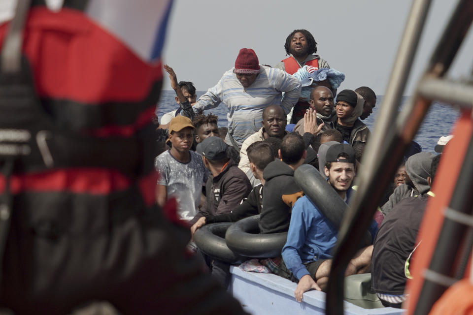 Migrants react to SOS Mediterranee's team during a rescue operation some 53 nautical miles (98 kilometers) from the coast of Libya in the Mediterranean Sea, Tuesday, Sept. 17, 2019. The humanitarian rescue ship Ocean Viking pulled 48 people from a small and overcrowded wooden boat including a newborn and a pregnant woman. (AP Photo/Renata Brito)