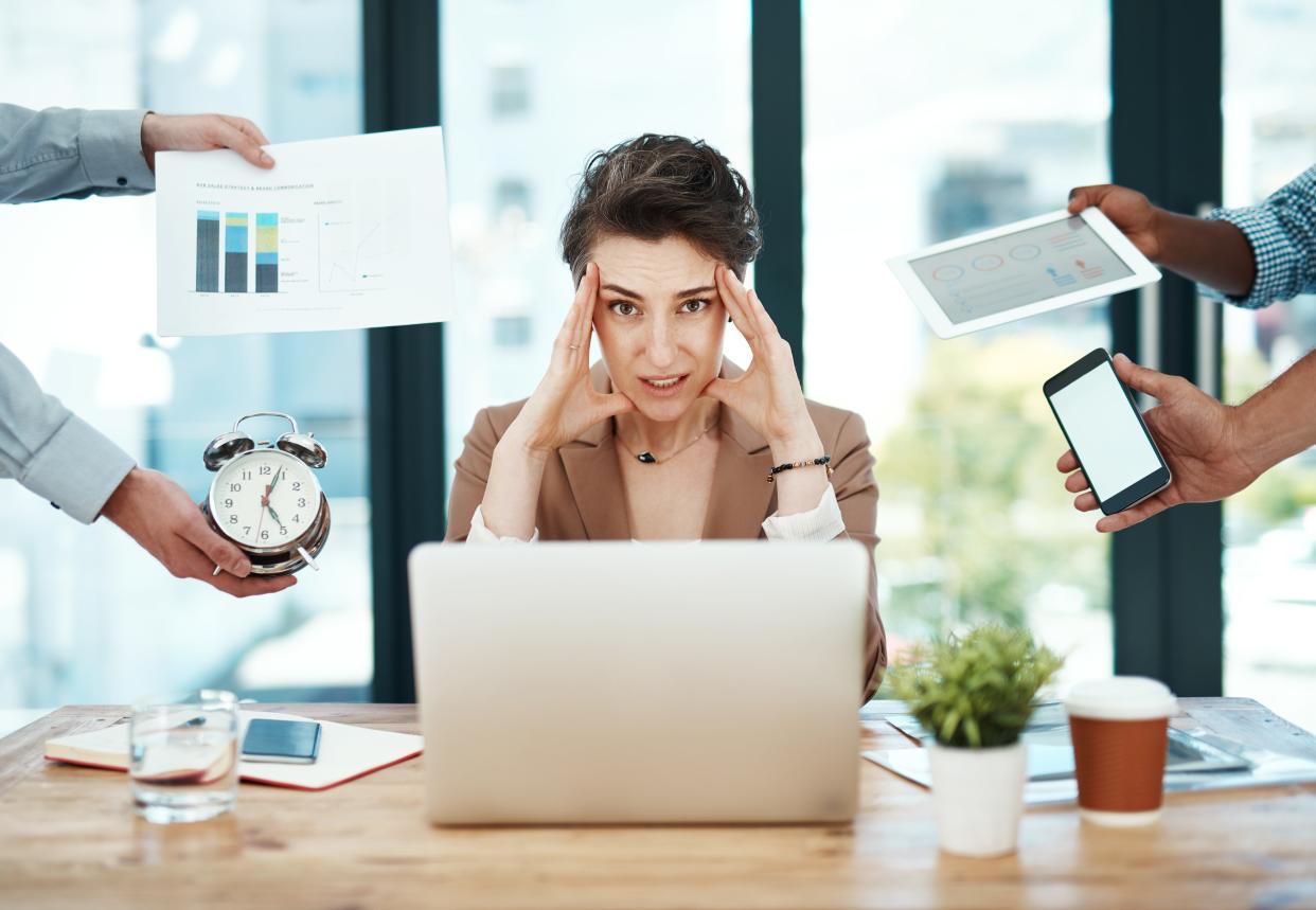 Shot of a young businesswoman looking stressed out in a demanding office environment