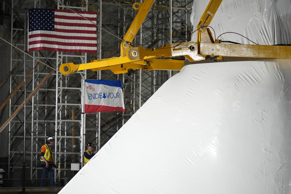 Space Shuttle Endeavour is lifted into the site of the future Samuel Oschin Air and Space Center on Tuesday, Jan. 30, 2024, in Los Angeles. (AP Photo/Ashley Landis)