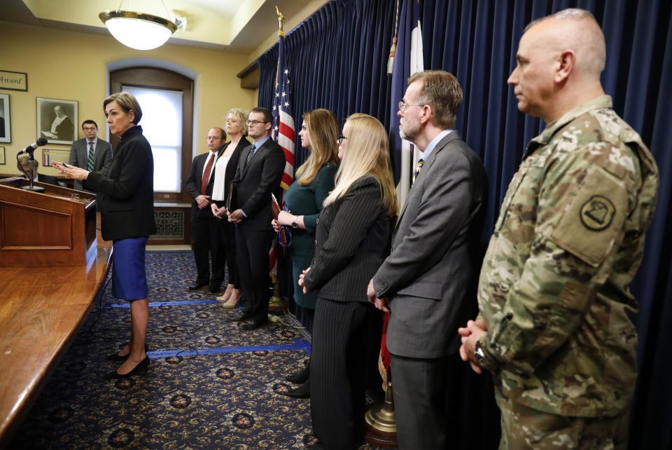 Iowa Gov. Kim Reynolds, left, speaks during a news conference about an update on the state's response to the new coronavirus outbreak, Tuesday, March 10, 2020, at the Statehouse in Des Moines, Iowa. (AP Photo/Charlie Neibergall)