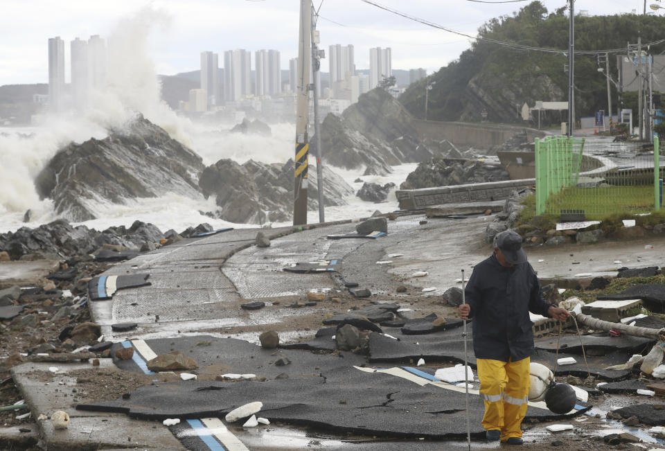 A road is damaged as waves hit a shore in Ulsan, South Korea, Tuesday, Sept. 6, 2022. The most powerful typhoon to hit South Korea in years battered its southern region Tuesday, dumping almost a meter (3 feet) of rain, destroying roads and felling power lines, leaving 20,000 homes without electricity as thousands of people fled to safer ground. (Kim Yong-tai/Yonhap via AP)