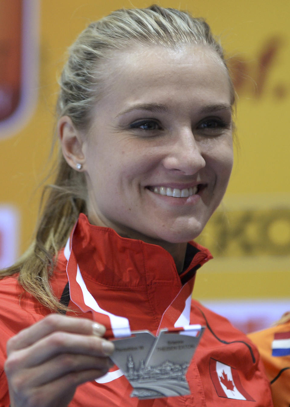 Canada's Brianne Theisen Eaton sports her silver medal after the women's pentathlon during the Athletics Indoor World Championships in Sopot, Poland, Friday, March 7, 2014. (AP Photo/Alik Keplicz)