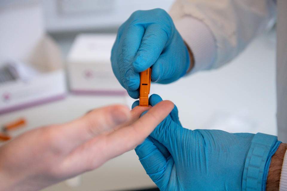 Capillary blood is drawn from a fingertip during a demonstration at SureScreen Diagnostics, based in Derby, of a test they have manufactured which claims to be 98% accurate in determining if a person is infected with coronavirus, costs £6 and can be used in 10 minutes. (Photo by Jacob King/PA Images via Getty Images)