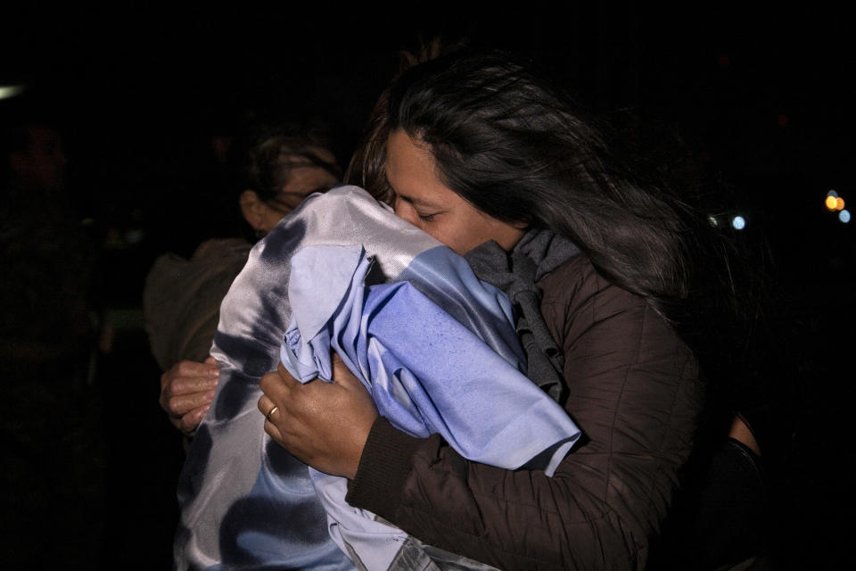 Relatives of the crew of the ARA San Juan submarine embrace outside the navy base in Mar del Plata, Argentina, Saturday, Nov. 17, 2018. Argentina's navy announced early Saturday, that they have located the missing submarine ARA San Juan in the Atlantic a year after it disappeared with 44 crew members aboard.(AP Photo/Federico Cosso)