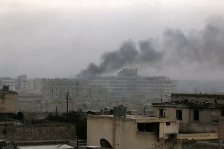 Smoke rises after strikes on the rebel-held besieged neighbourhoods of eastern Aleppo, Syria December 5, 2016. REUTERS/Abdalrhman Ismail