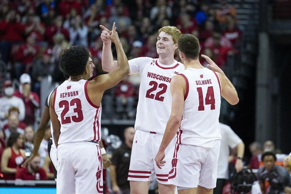 Wisconsin's Steven Crowl (22) celebrates after his 3-point basket with Chucky Hepburn (23) and Carter Gilmore during the second half of an NCAA college basketball game against Western Michigan, Friday, Dec. 30, 2022, in Madison, Wis. (AP Photo/Andy Manis)