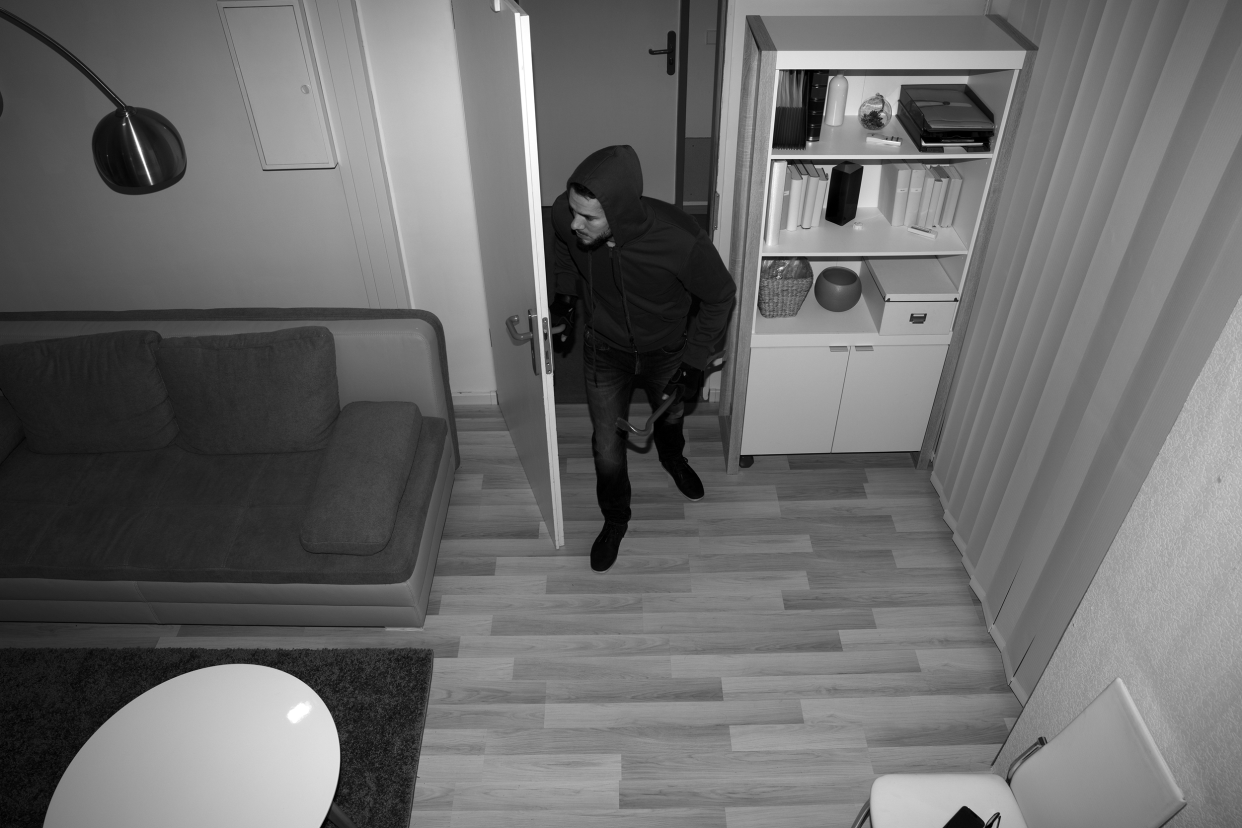 Burglar entering a home