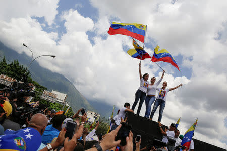 Lilian Tintori (R), wife of jailed Venezuelan opposition leader Leopoldo Lopez attends a rally to demand a referendum to remove Venezuela's President Nicolas Maduro, next to Venezuelan opposition leader Maria Corina Machado (C) and Patricia Ceballos, mayor of San Cristobal and wife of jailed former mayor Daniel Ceballos, in Caracas, Venezuela October 22, 2016. REUTERS/Marco Bello