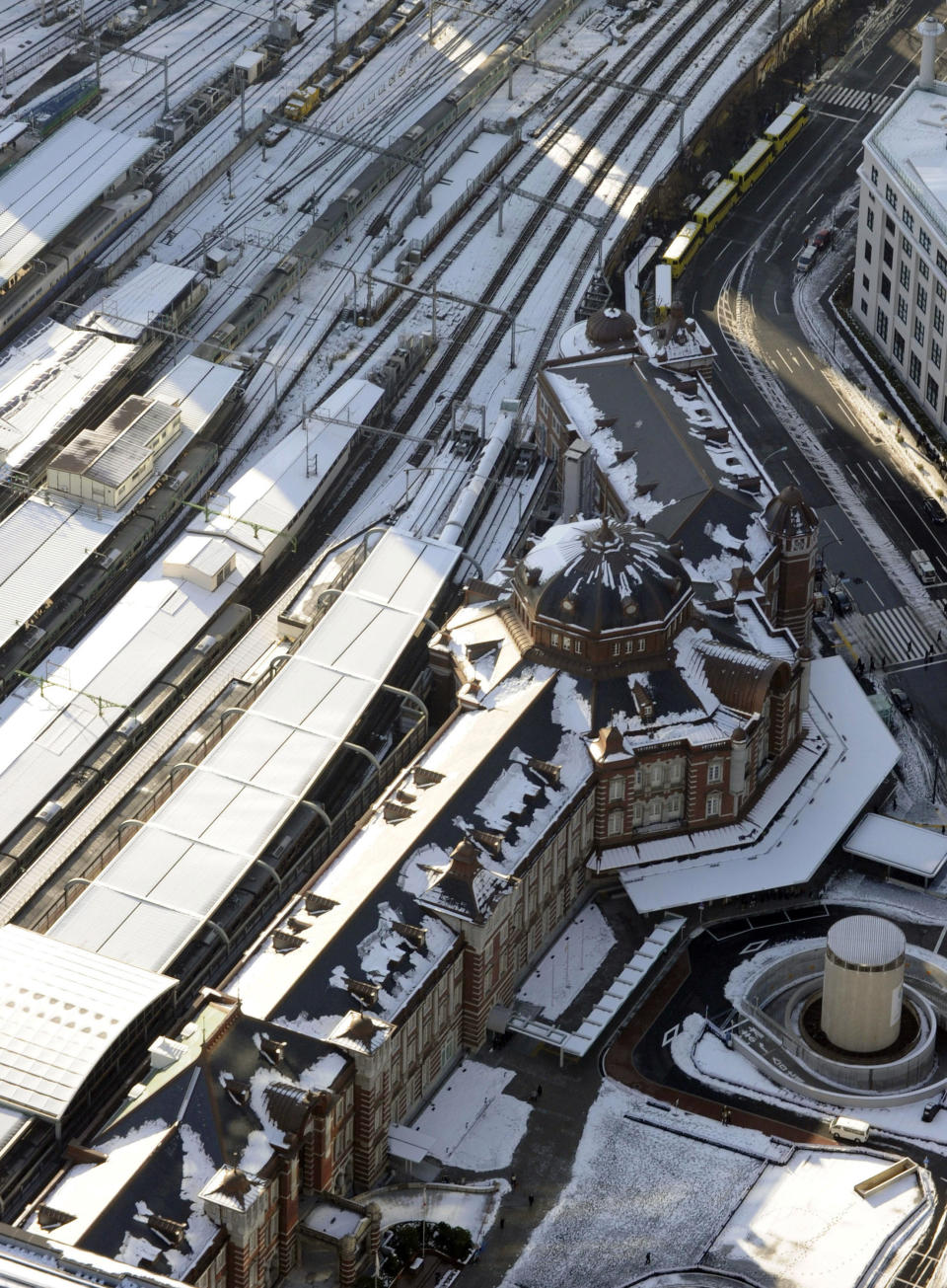 Tokyo Station is still covered with snow in Tokyo Tuesday, Jan. 15, 2013 following Monday's snowfall. In the season's first snowfall in the Japanese capital, about 8 centimeters (3 inches) of snow fell in central Tokyo and around Narita on Monday - a national holiday in Japan. The snow snarled traffic and caused train delays. (AP Photo/Kyodo News) JAPAN OUT, MANDATORY CREDIT, NO LICENSING IN CHINA, HONG KONG, JAPAN, SOUTH KOREA AND FRANCE
