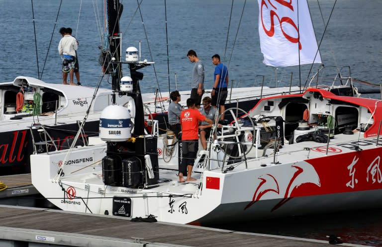 Crew members from team Dongfeng from the Volvo Ocean Race work onboard their yacht