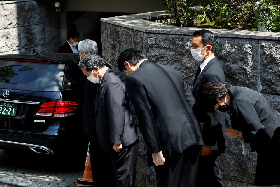 Japanese lawmaker Sanae Takaichi prays to the vehicle believed to be carrying the body of former Japanese Prime Minister Shinzo Abe, who was shot while campaigning for a parliamentary election, at his residence in Tokyo, Japan July 9, 2022. REUTERS/ Kim Kyung-Hoon