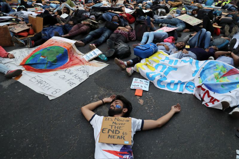 People stage a die-in during a Global Climate Strike rally calling for urgent measures to combat climate change, in New Delhi