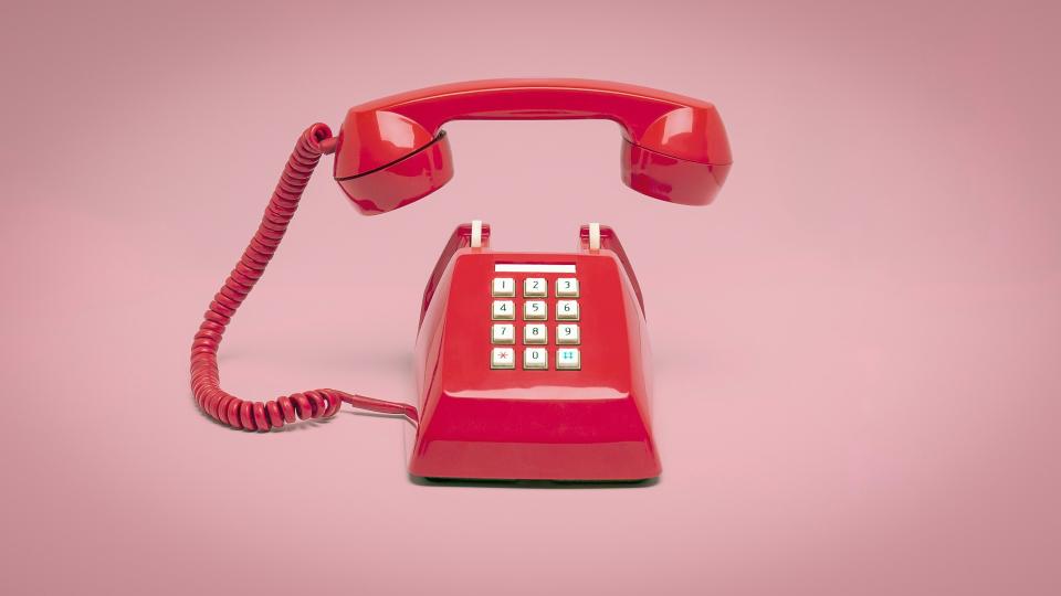 Retro pink telephone on pink background, Vintage style colors.