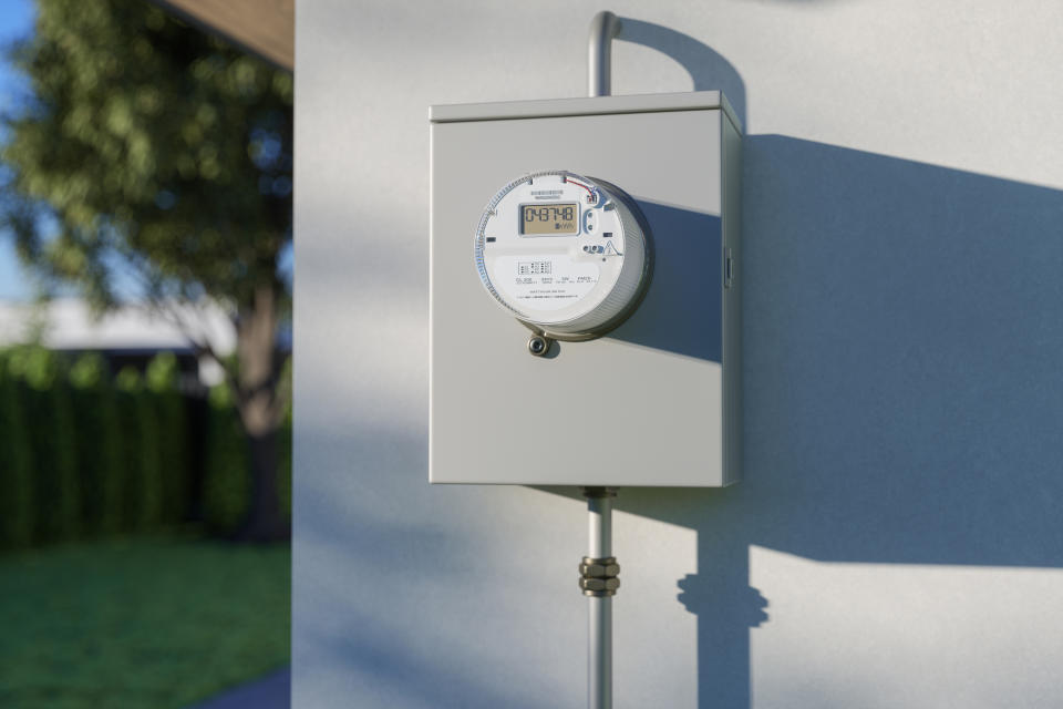 Utility meter on wall displaying digital readings