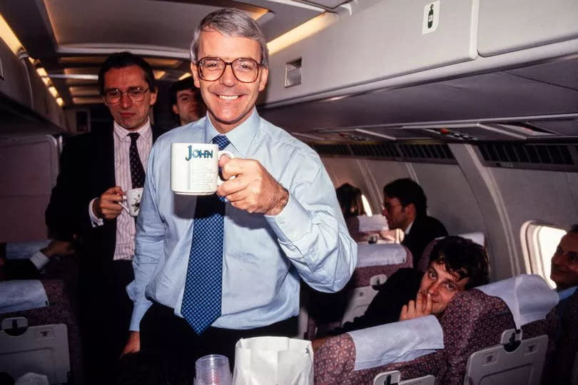 John Major shows his 'John' mug on the Conservative Party's campaign aircraft during the 1992 general election