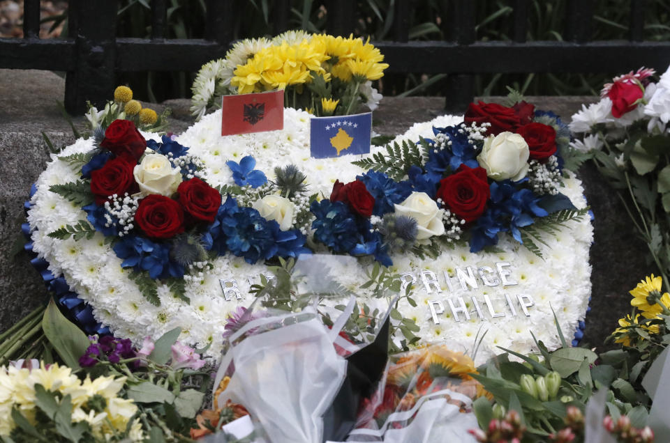 A flower wreath is left outside the gates of Windsor Castle, a day after the death of Britain's Prince Philip, in Windsor, England, Saturday, April 10, 2021. Britain's Prince Philip, the irascible and tough-minded husband of Queen Elizabeth II who spent more than seven decades supporting his wife in a role that mostly defined his life, died on Friday. (AP Photo/Frank Augstein)