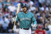 Seattle Mariners' Eugenio Suárez flips his bat after earning a walk from Los Angeles Angels pitcher Patrick Sandoval during the first inning of a baseball game, Friday, Aug. 5, 2022, in Seattle. (AP Photo/Stephen Brashear)