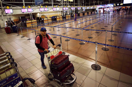 A passenger wait for his flight at the departures area of Latam airlines inside the international airport in Santiago, Chile August 16, 2018. REUTERS/Rodrigo Garrido