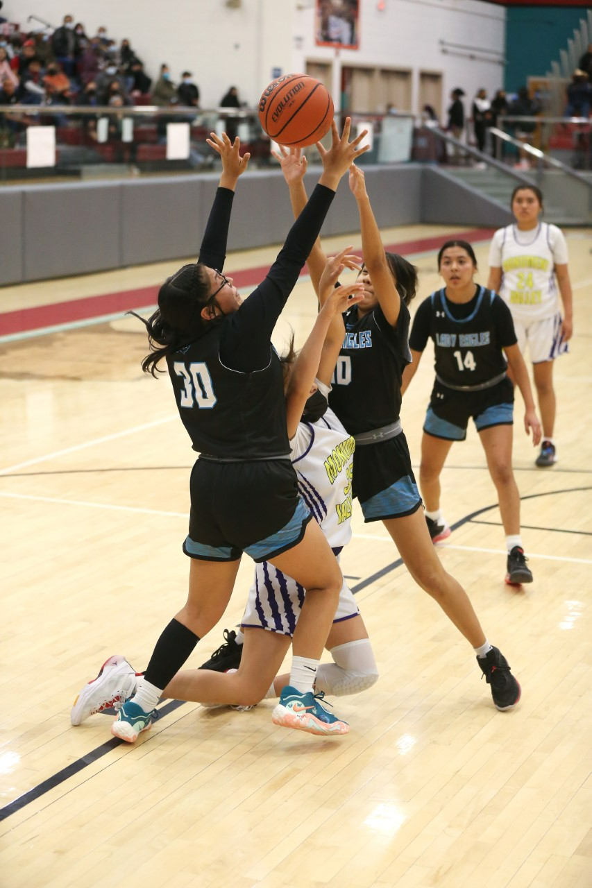 Navajo Prep's Kayla Mitchell (30) and Harmony Boone trap and force Monument Valley Utah's Raeni Nez to turn over the ball in the second quarter of the Jerry Richardson Memorial Tournament championship game on Saturday, December 3, 2022 at the Chieftain Pit.