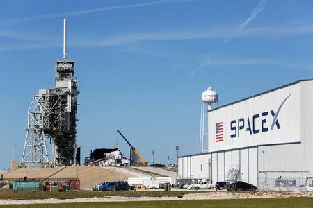 FILE PHOTO: A SpaceX Falcon 9 rocket (in center, in a horizontal position), is readied for launch on a supply mission to the International Space Station on historic launch pad 39A at the Kennedy Space Center in Cape Canaveral, Florida, U.S., February 17, 2017. REUTERS/Joe Skipper