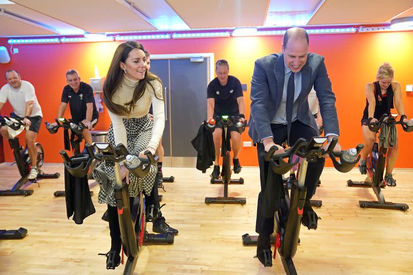 Prince William, Prince of Wales and Catherine, Princess of Wales take part in a spin class during a visit to Aberavon Leisure and Fitness Centre in Port Talbot